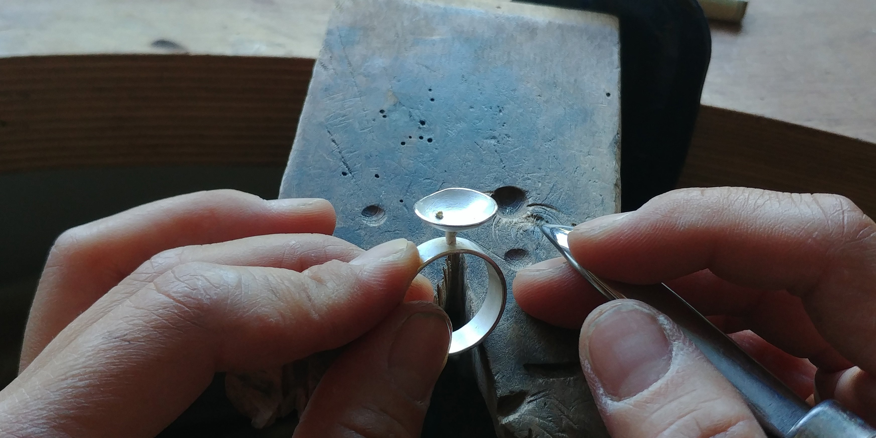 Close of of silver ring being finished
