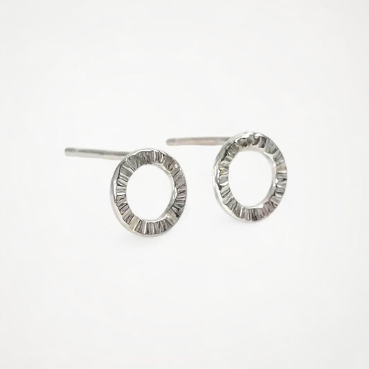 Pair of silver stud earrings on a white background