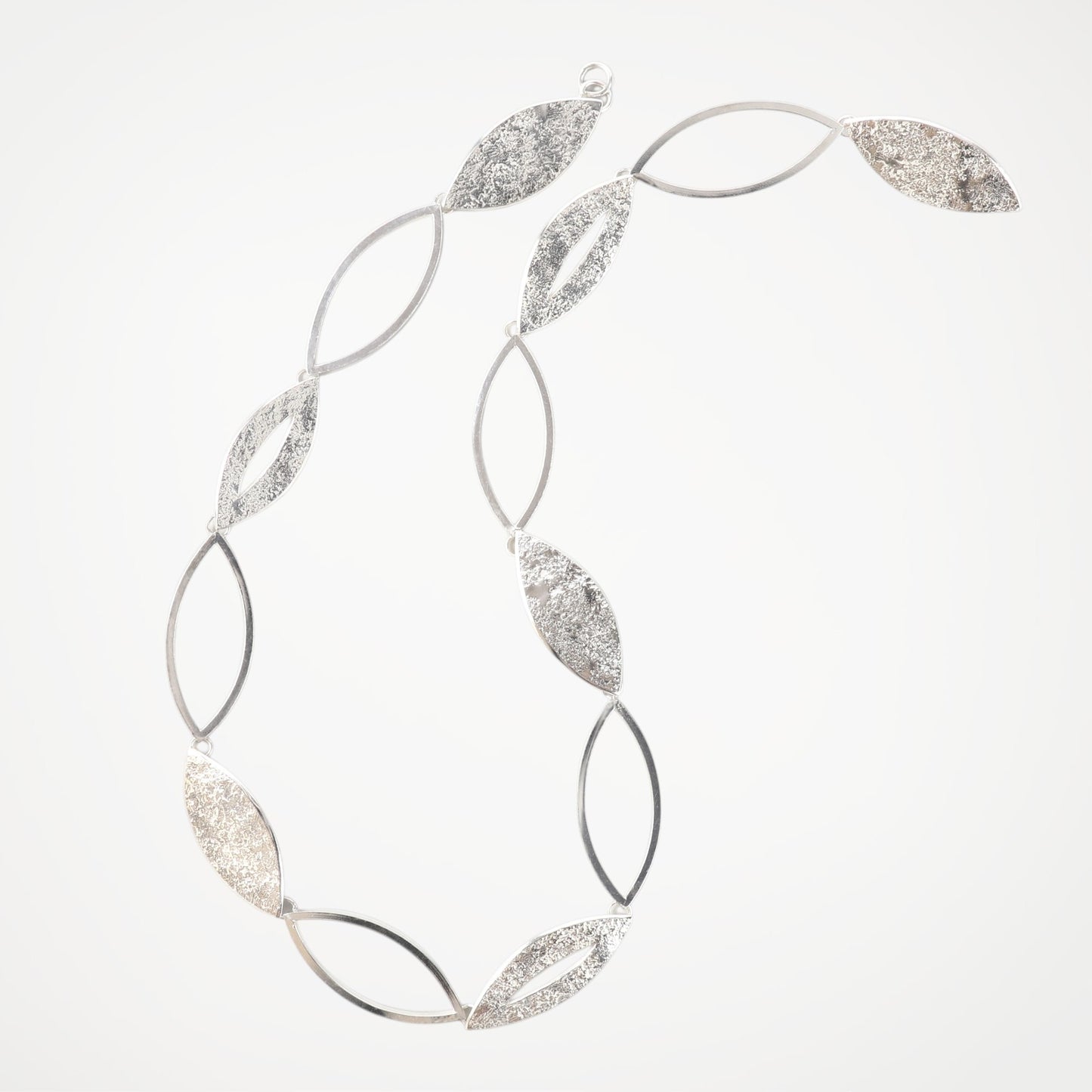Contemporary sterling silver statement necklace from the Marquise Collection, handcrafted with alternating open and textured marquise links.