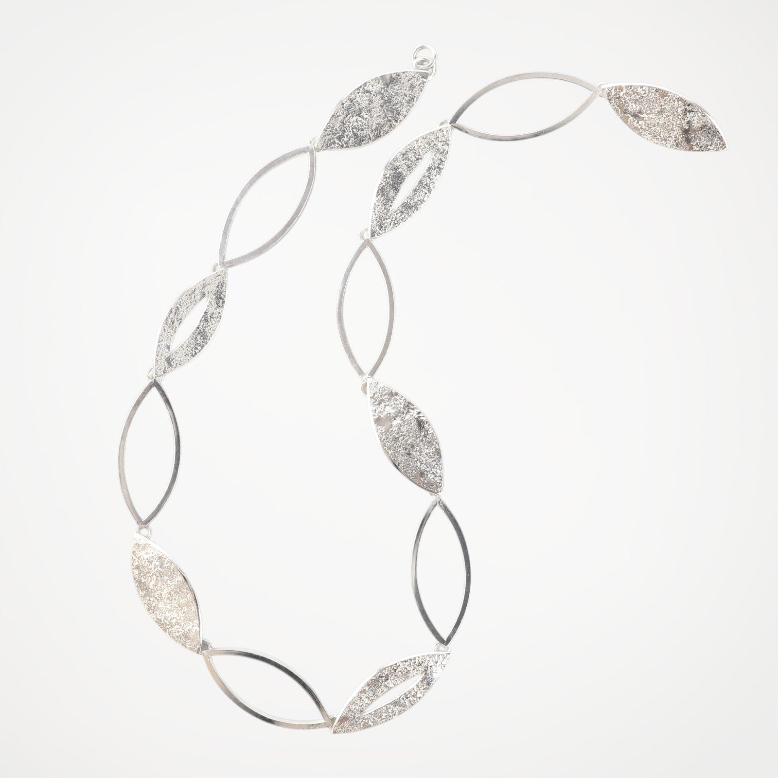 Contemporary sterling silver statement necklace from the Marquise Collection, handcrafted with alternating open and textured marquise links.