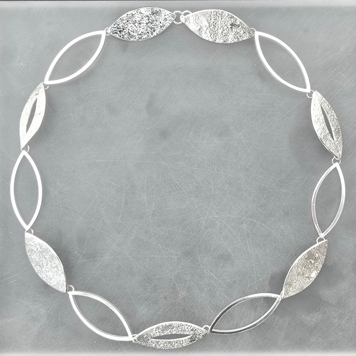Contemporary sterling silver statement necklace from the Marquise Collection, handcrafted with alternating open and textured marquise links.