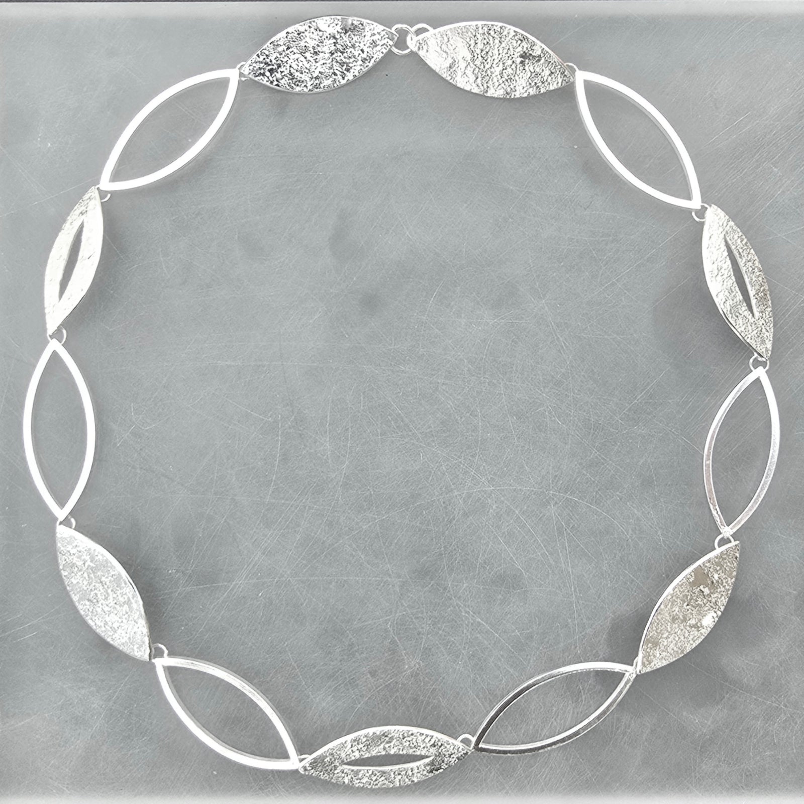 Contemporary sterling silver statement necklace from the Marquise Collection, handcrafted with alternating open and textured marquise links.
