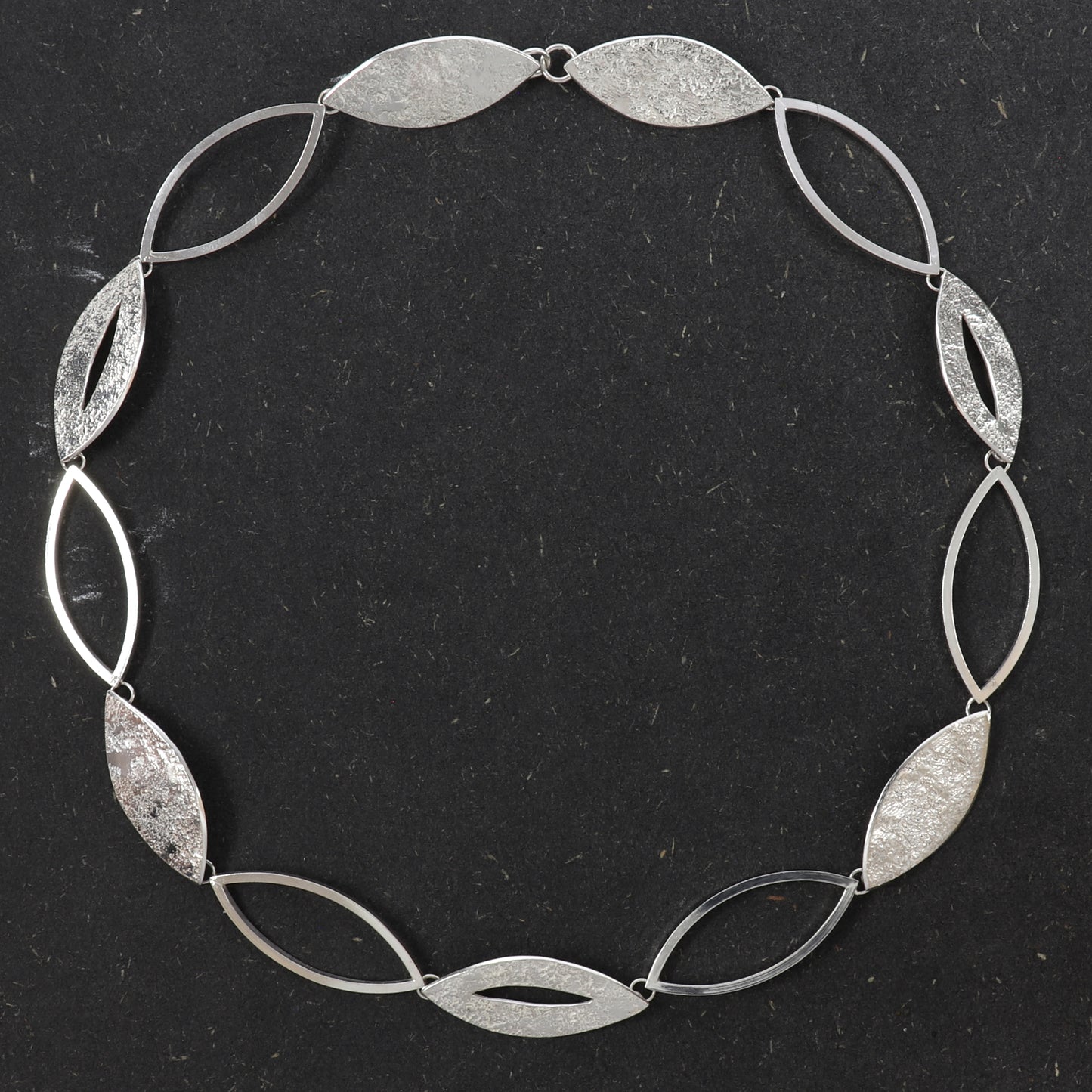 Handcrafted sterling silver Marquise Statement Necklace featuring alternating textured and open marquise links with a concealed clasp.