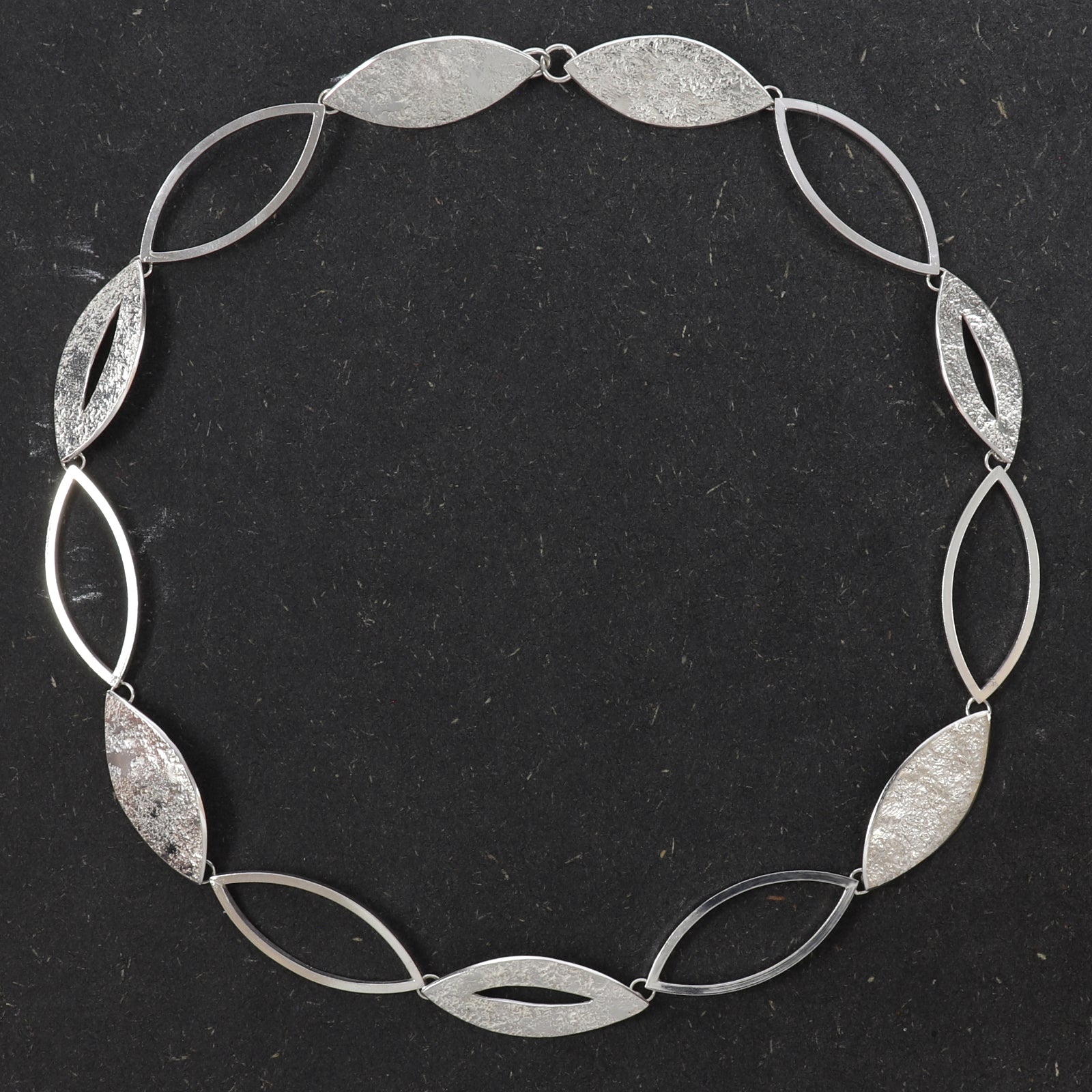 Handcrafted sterling silver Marquise Statement Necklace featuring alternating textured and open marquise links with a concealed clasp.