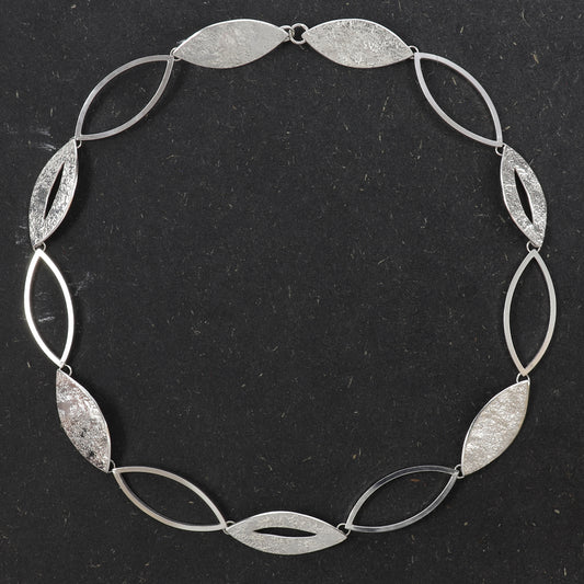 Handcrafted sterling silver Marquise Statement Necklace featuring alternating textured and open marquise links with a concealed clasp.
