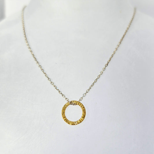 Sterling silver circular pendant necklace with hand-textured surface, finished in yellow gold vermeil.