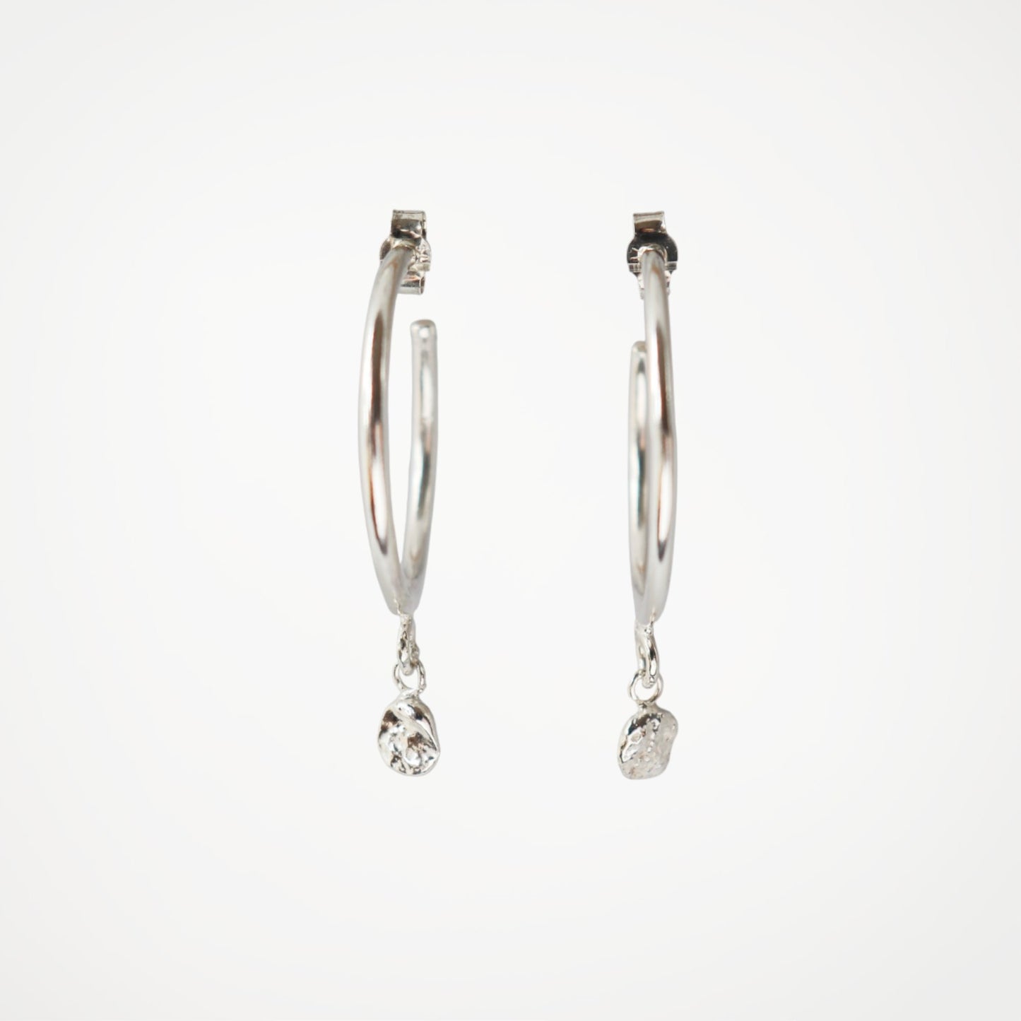 Sterling silver hoop earrings with molten silver drop detail