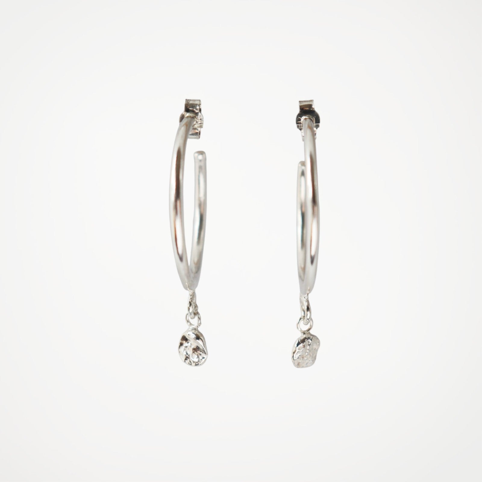 Sterling silver hoop earrings with molten silver drop detail