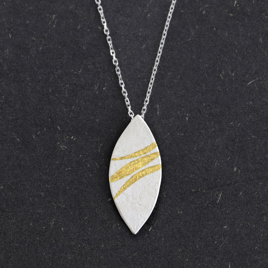Handcrafted sterling silver marquise pendant with 24ct gold Keum-Boo ribbons by Jenny Holdsworth