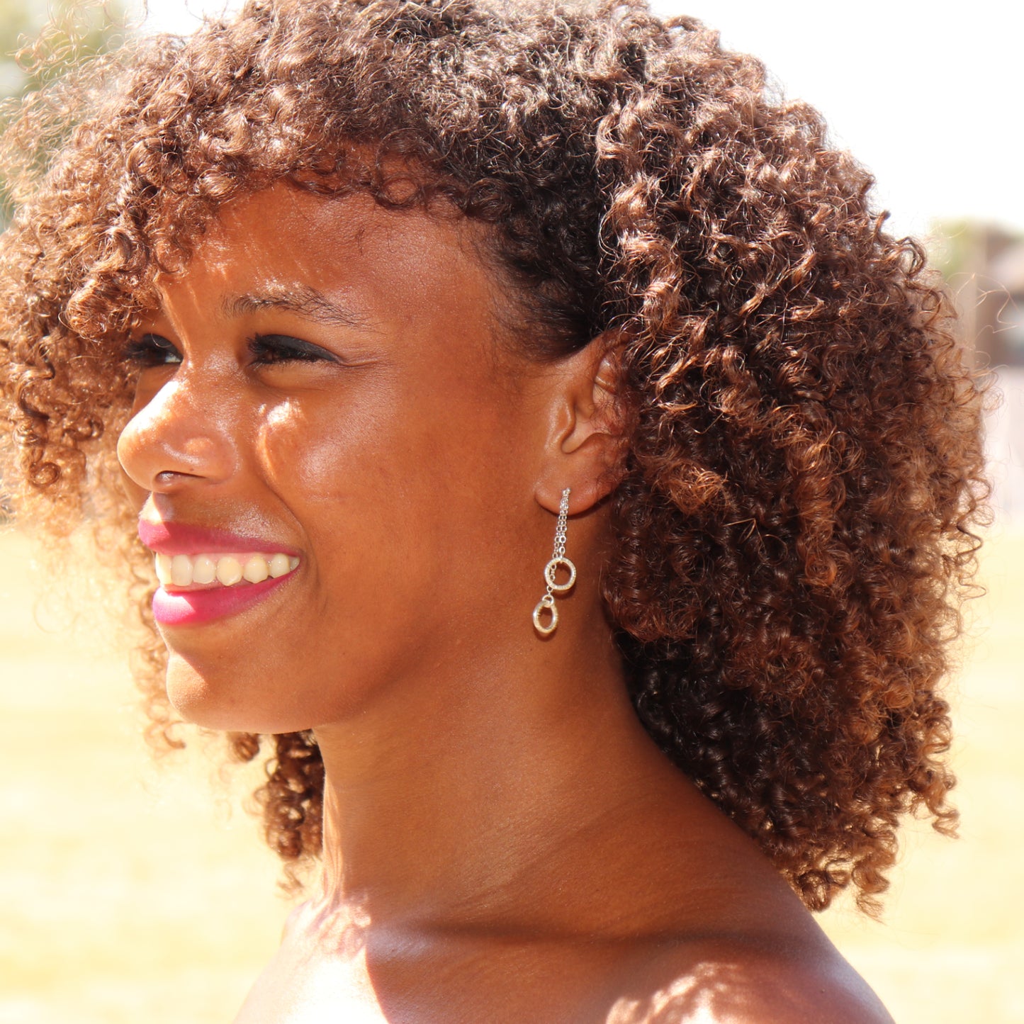 Sterling silver double circle drop earrings worn, 40mm drop length.
