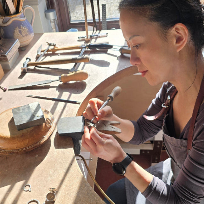 jenny holdsworth silversmith making jewellery on her bench