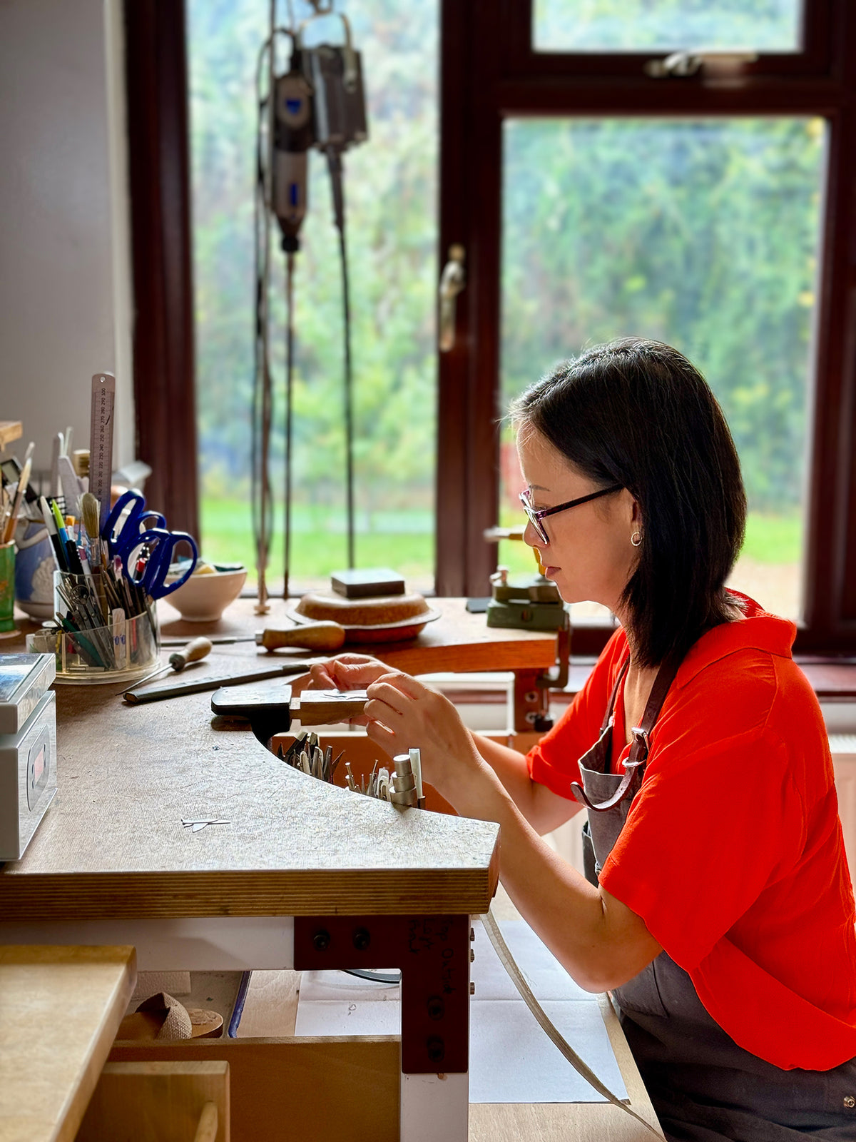 jeweller jenny holdsworth on her jewellery bench
