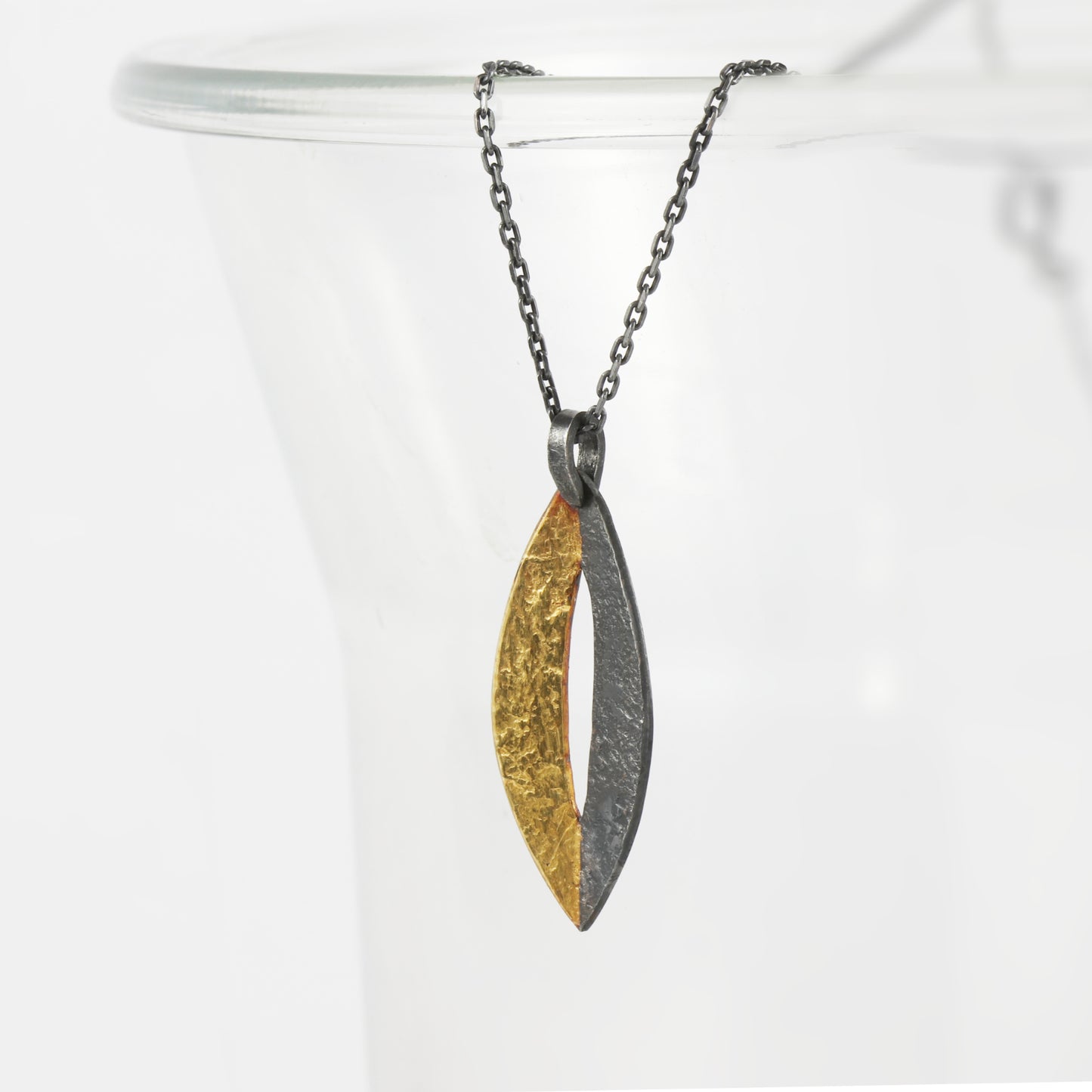 Handcrafted sterling silver marquise pendant with oxidised finish and 24ct gold Keum-Boo detail by Jenny Holdsworth