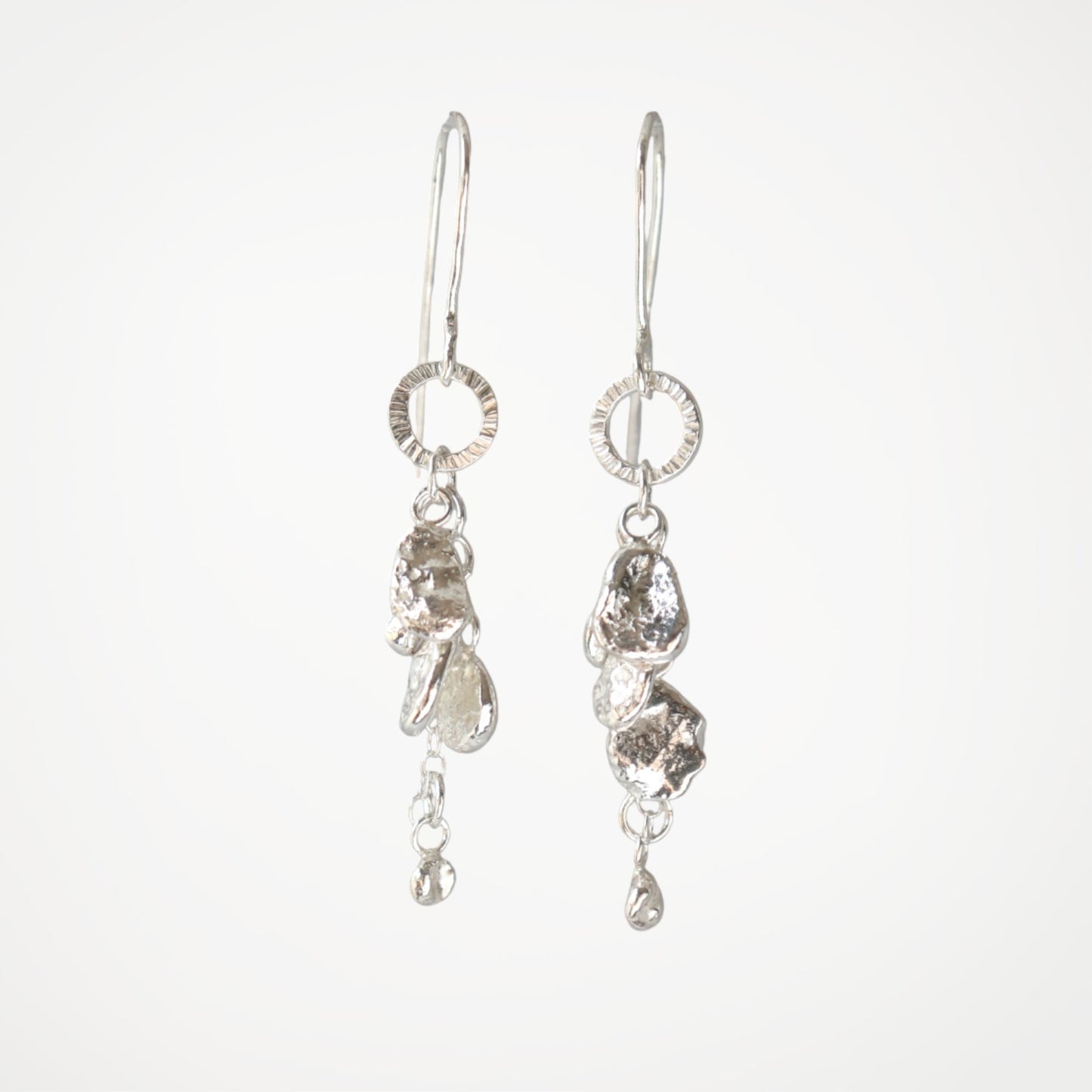 Sterling silver drop earrings from the Molten Drops collection with organic silver drops