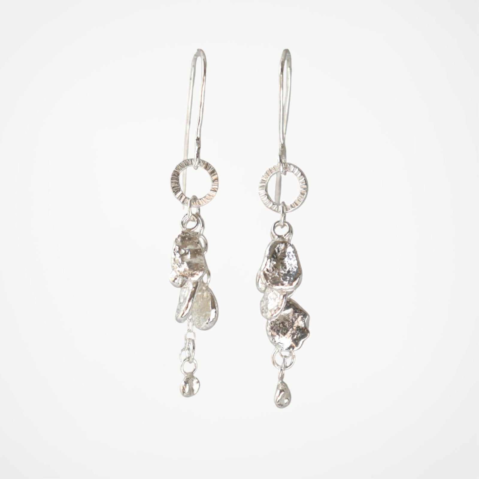 Sterling silver drop earrings from the Molten Drops collection with organic silver drops
