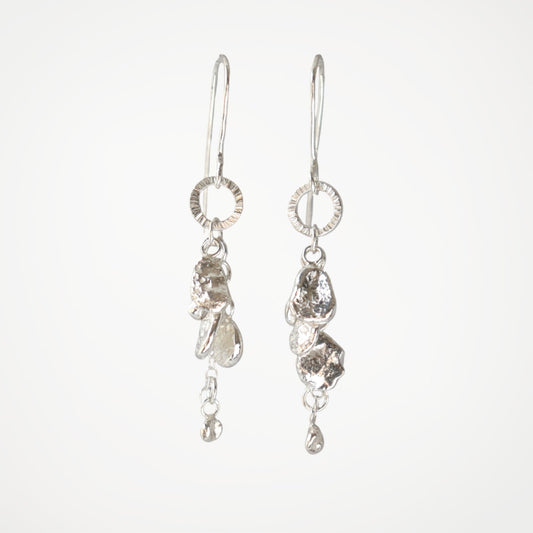 Sterling silver drop earrings from the Molten Drops collection with organic silver drops