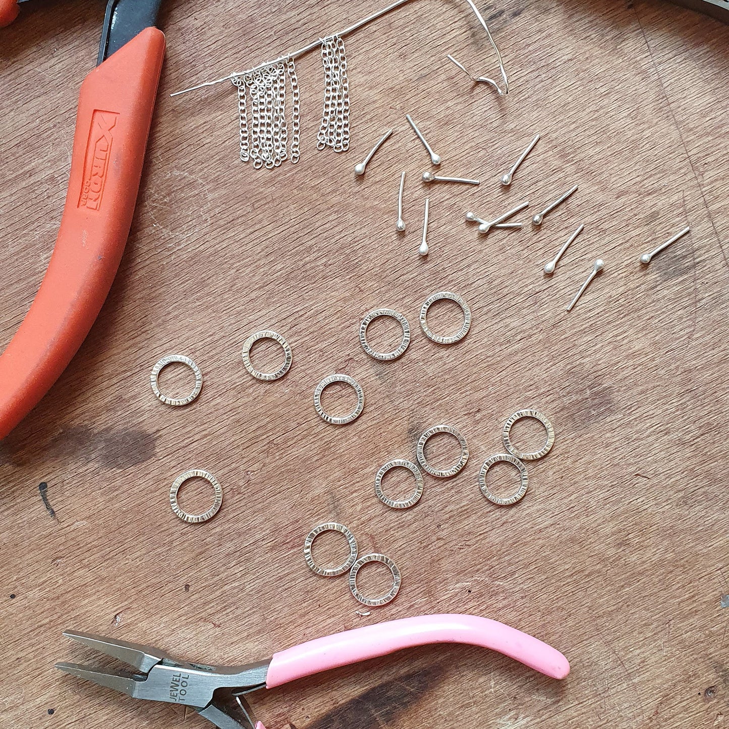 parts for making silver jewellery on a bench