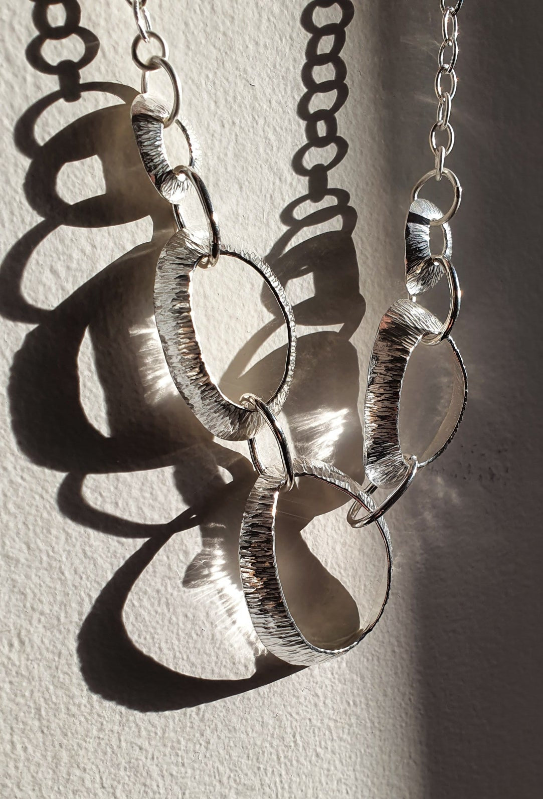 silver necklace with hammered limpet inspired shapes