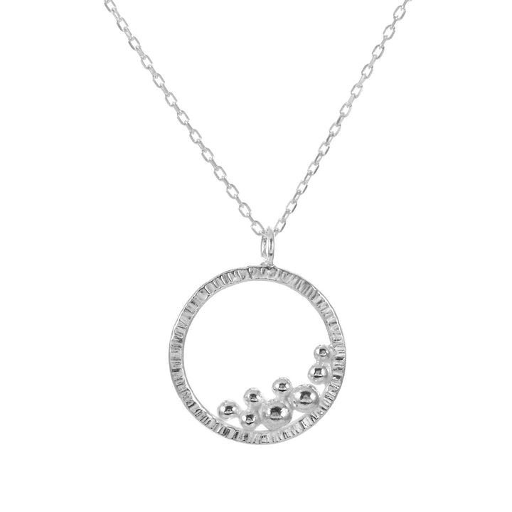 Circle necklace with a cluster of silver balls