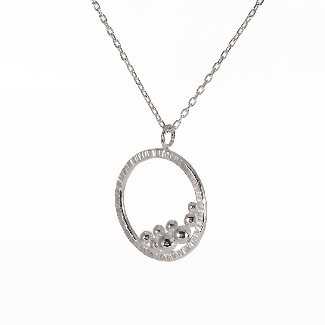 Circle necklace with a cluster of silver balls