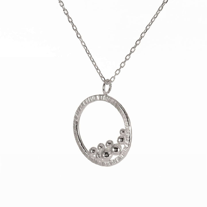 Circle necklace with a cluster of silver balls