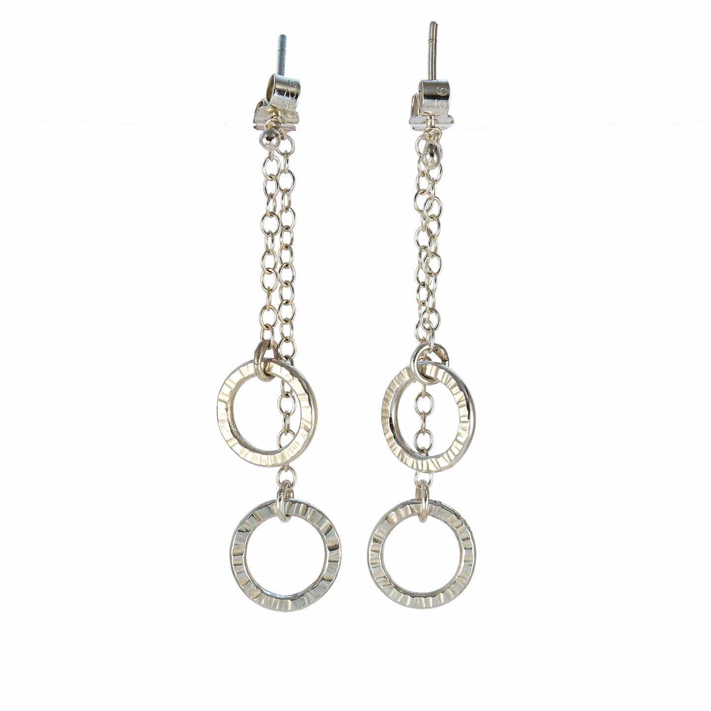 Sterling silver double circle drop earrings with hand-textured rings suspended from fine chain.