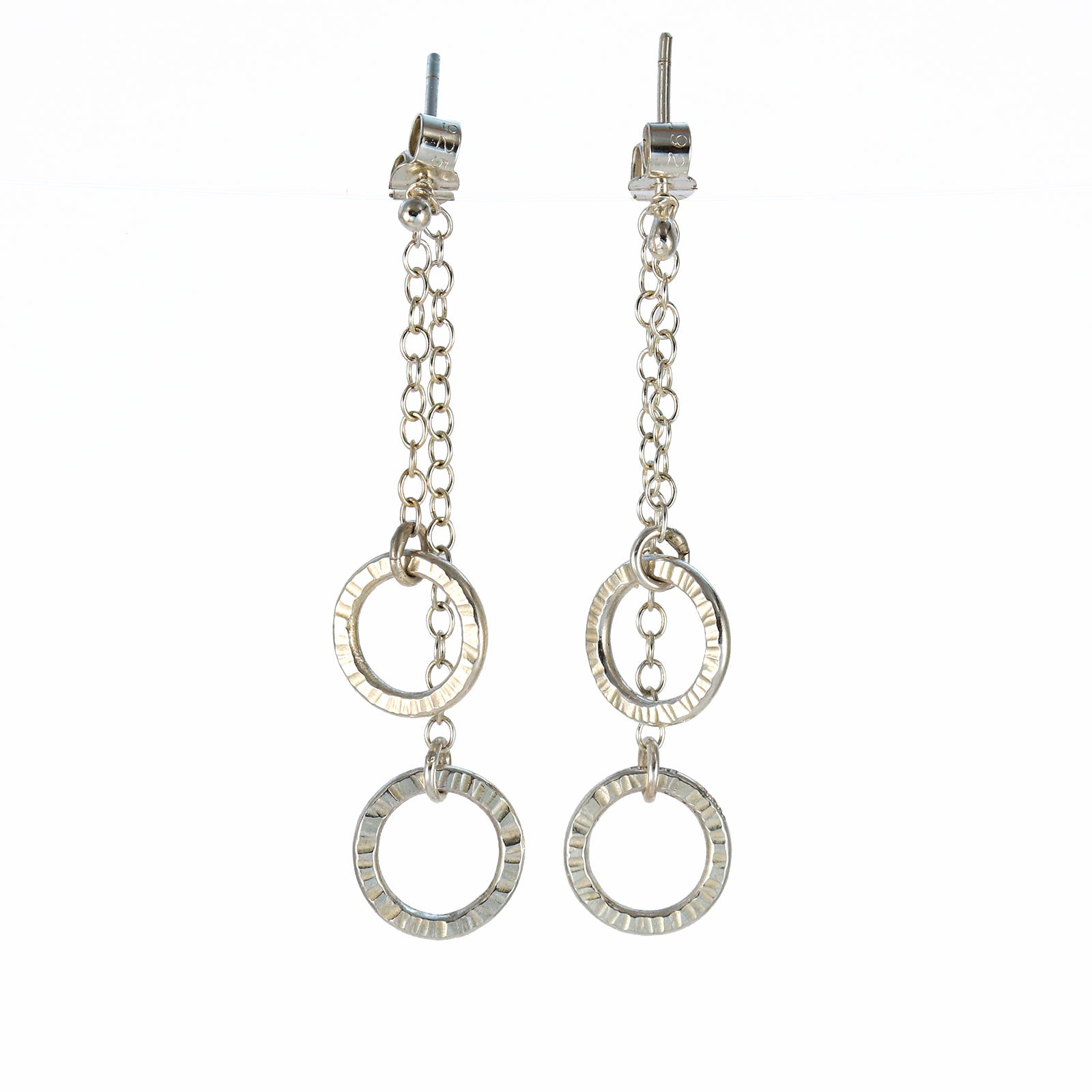 Sterling silver double circle drop earrings with hand-textured rings suspended from fine chain.