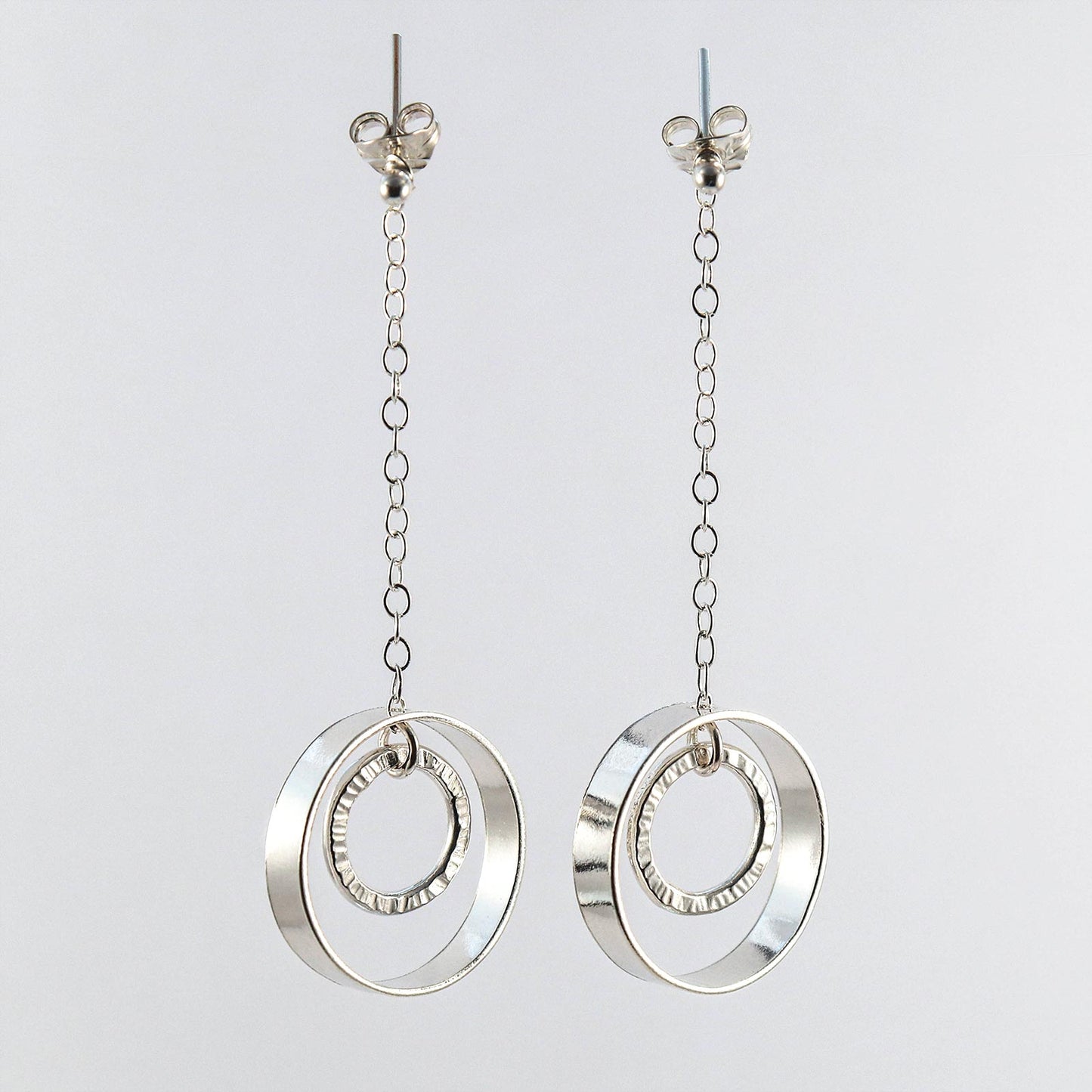 Sterling silver linked circle drop earrings worn on model