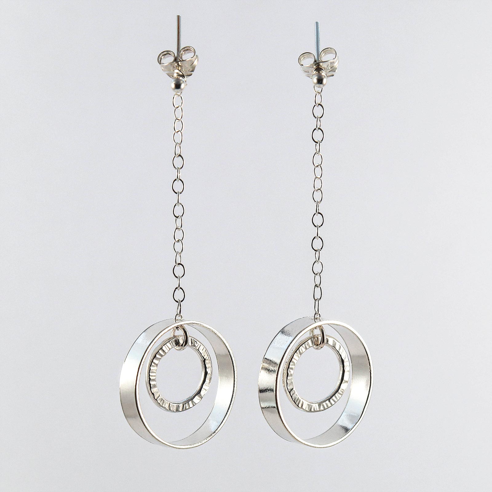 Sterling silver linked circle drop earrings worn on model