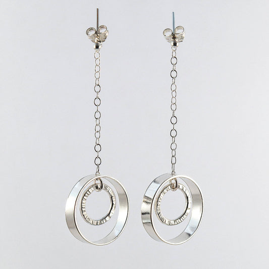 Sterling silver linked circle drop earrings worn on model